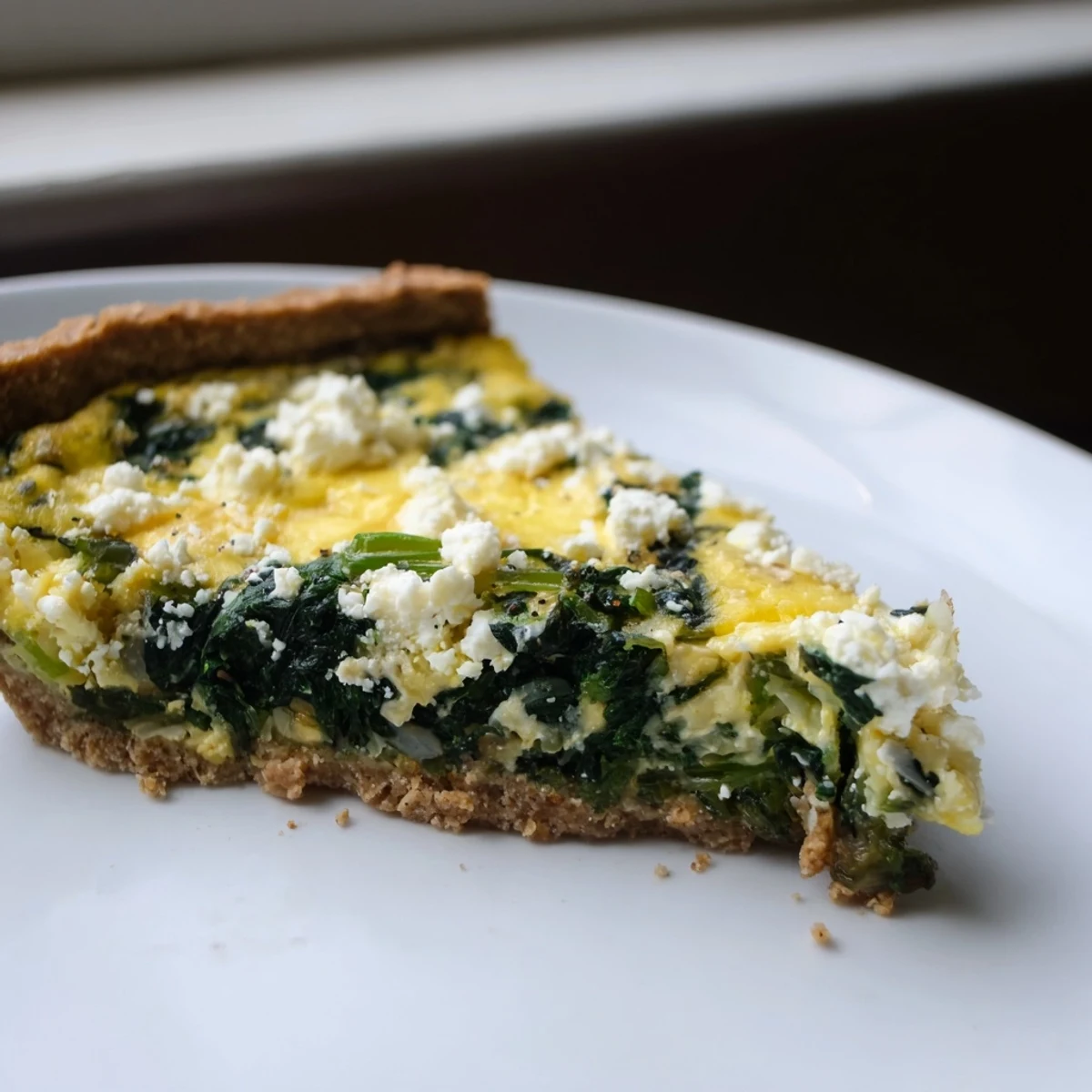 Healthy Spinach & Goat Cheese Quiche, fresh from the oven, with a golden-brown crust and creamy filling.