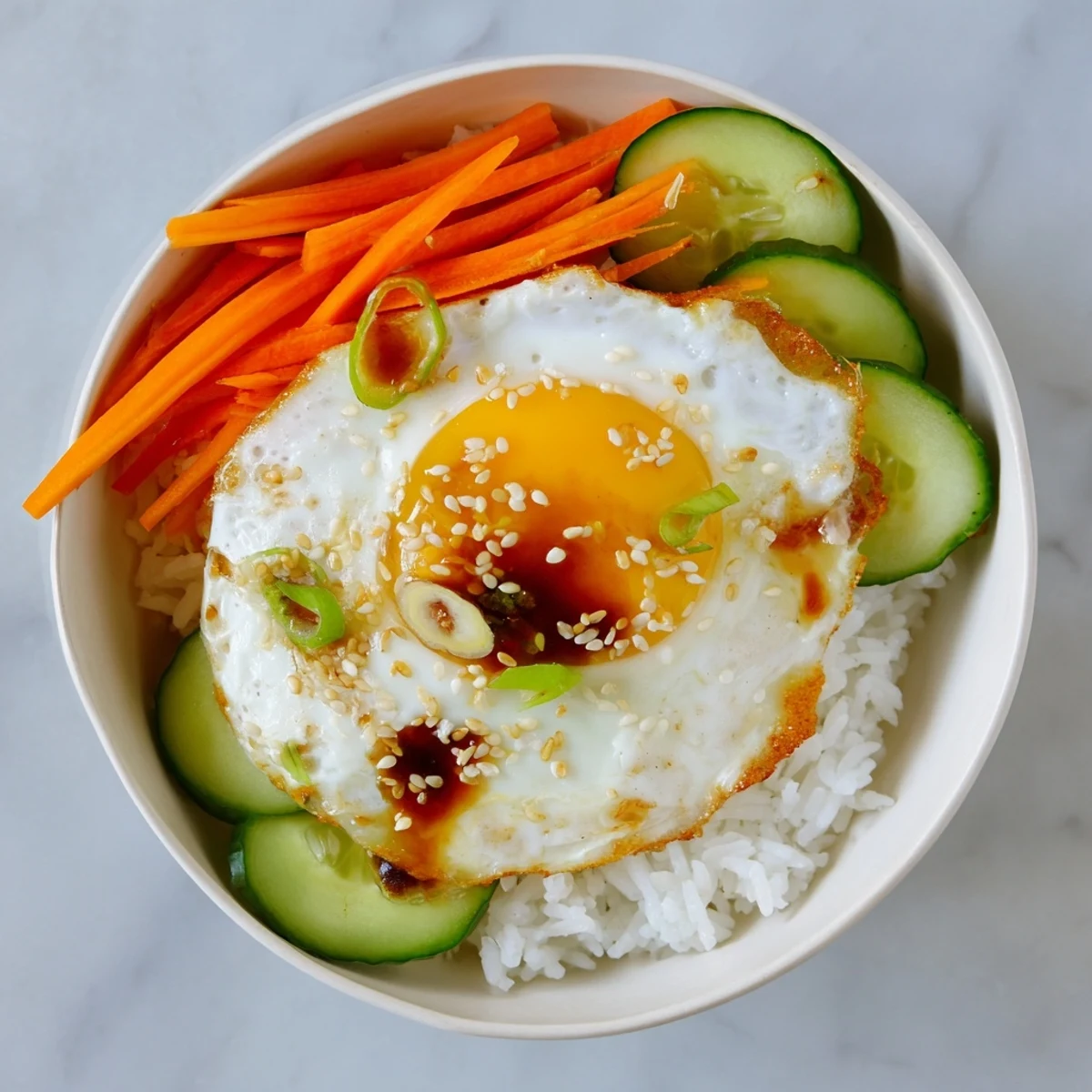 This delicious Crispy Egg Rice Bowl features perfectly fried egg and tender vegetables over golden rice.