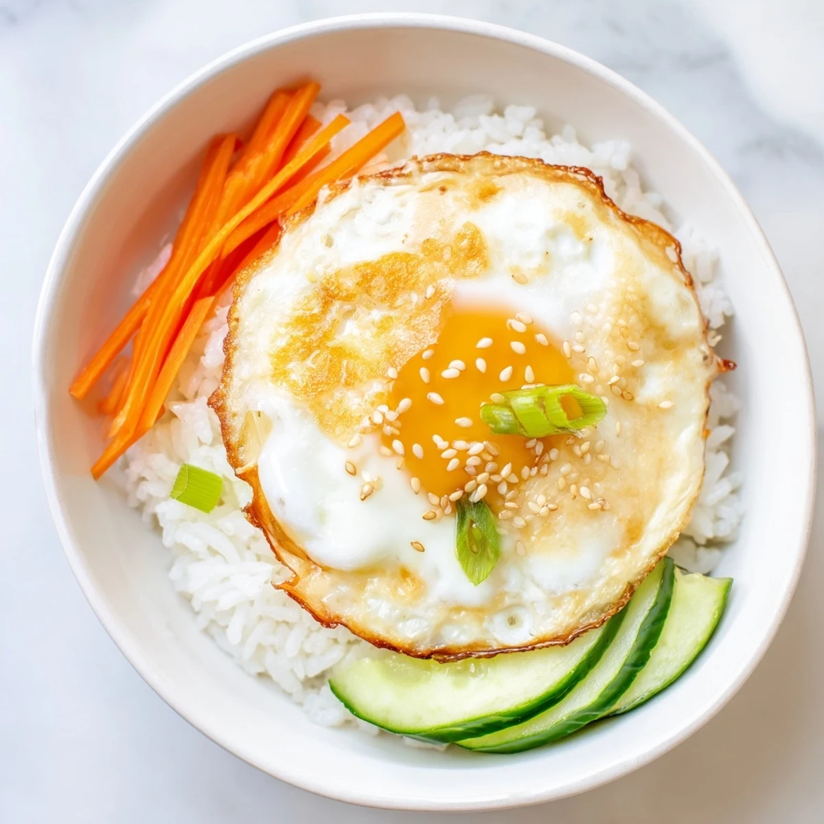 Enjoy a satisfying Crispy Egg Rice Bowl: a quick meal of crispy rice, a fried egg, and fresh toppings.