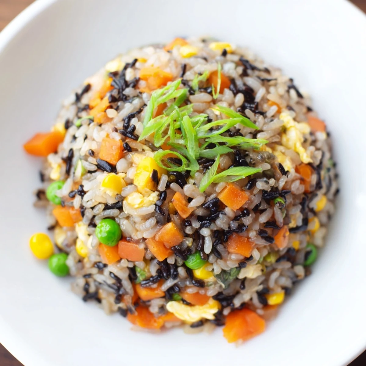 This fluffy plate of Black Garlic Fried Rice with egg and vegetables is a delicious Asian-inspired dinner.