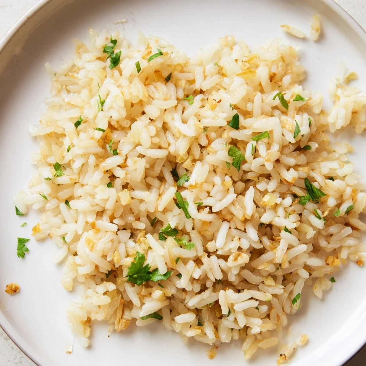 Close-up of golden Jasmine Rice Garlic, cooked to perfection, with fresh cilantro garnish.