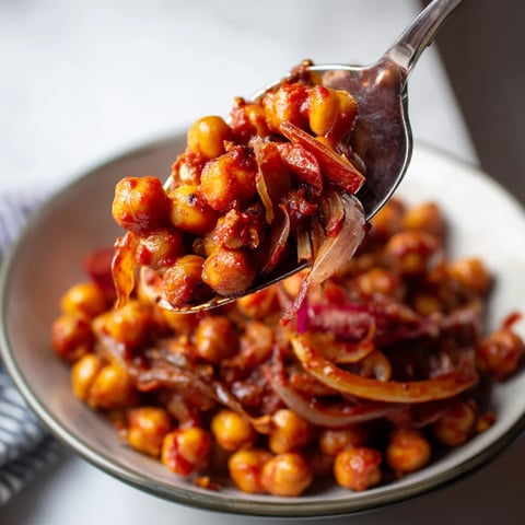 Une balle de chickpeas est servie dans un bol avec une cuillère.