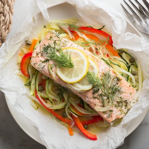 Filet de saumon en papillote moelleux avec aneth frais, citron et julienne de légumes d'été.