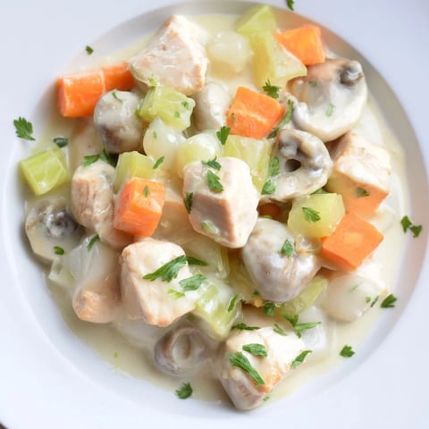 Mini Chicken Blanquette, a creamy French stew, with tender chicken and baby vegetables in view.