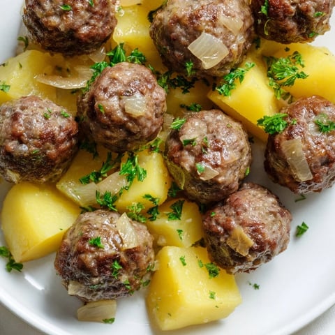 Juicy Budget Beef Meatballs with thyme-roasted potatoes, a hearty, flavorful family dinner ready soon.
