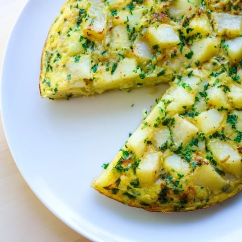Golden Potato & Herb Frittata, bubbly and browned, ready for a delicious brunch.