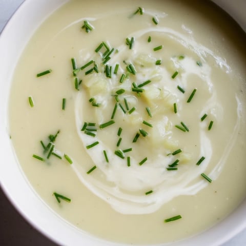 Creamy Leek and Potato Soup, garnished with fresh chives, ready to eat in a warm bowl.