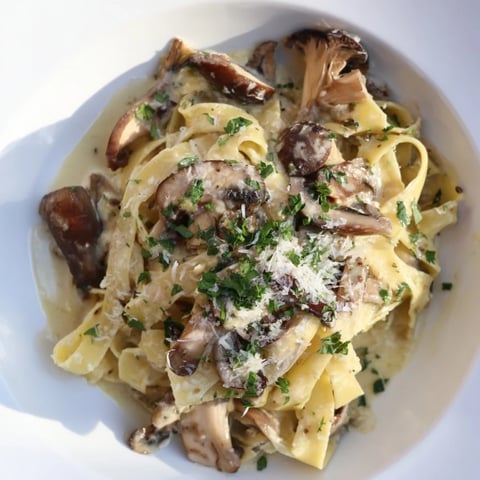 Sautéed mushrooms and creamy sauce coat the perfectly cooked mushroom pasta, ready to eat.