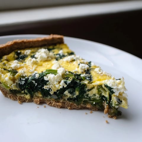 Healthy Spinach & Goat Cheese Quiche, fresh from the oven, with a golden-brown crust and creamy filling.