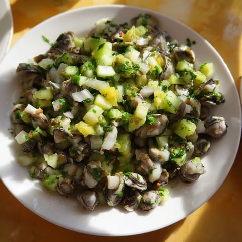 Fresh, chilled Budget-Friendly Oyster Tartare served with toasted bread and lemon wedges, a perfect appetizer.