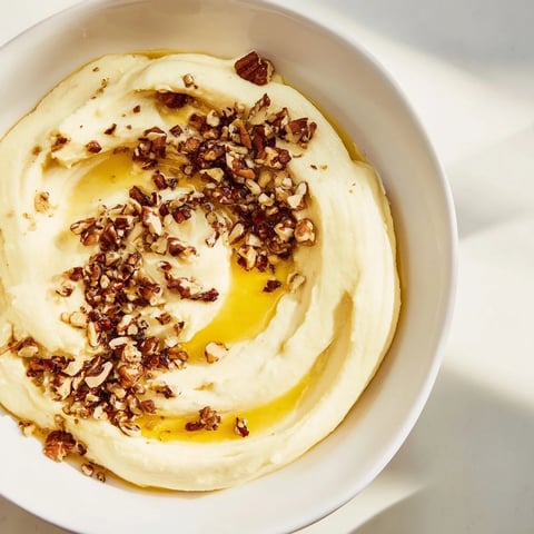 Creamy Chestnut Cream Cheese Spread drizzled with honey, ready to spread on toast; a perfect appetizer.