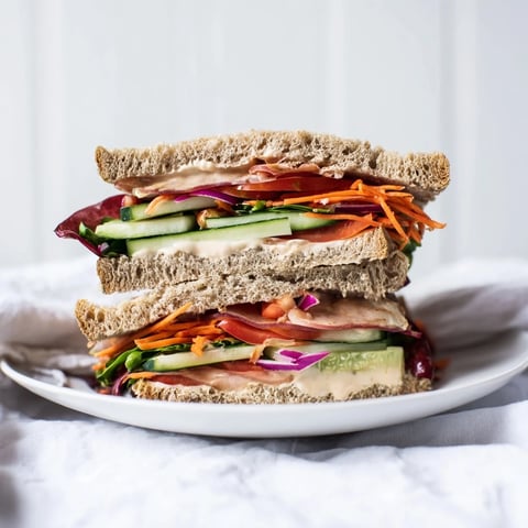 A vibrant Crunchy Dill Pickle Sandwich, filled with layered pickles and fresh veggies, ready to enjoy.