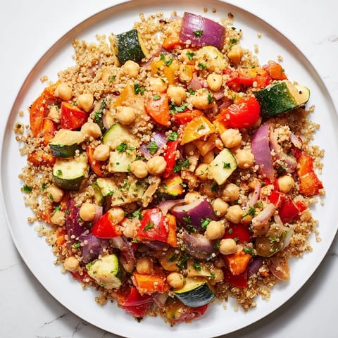 Warm bowl of Quinoa Power Salad: a colorful, healthy vegan salad with creamy tahini dressing.