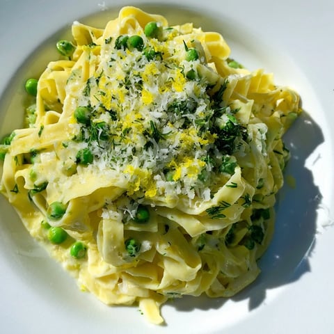 A bowl of Creamy Dill Pasta, a flavorful pasta dish with vibrant green herbs.