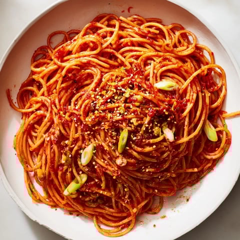 Garlic Chili Oil Noodles: a steaming bowl of flavorful noodles, glistening with chili oil and scallions.