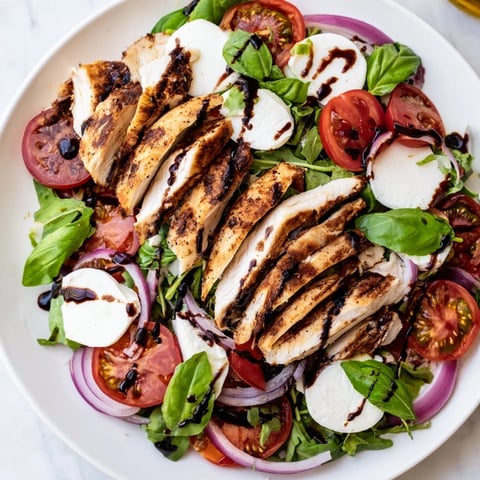Grilled Caprese Chicken Salad with juicy grilled chicken, ripe tomatoes, mozzarella and balsamic glaze.