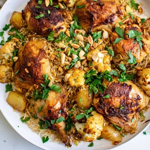 Aromatic Palestinian Maklouba, layers of seasoned rice, vegetables, and tender chicken, ready to serve.