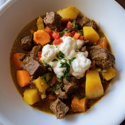 Aromatic Yemeni saltah stew, a hearty meal with layers of meat, vegetables, and fenugreek topping.