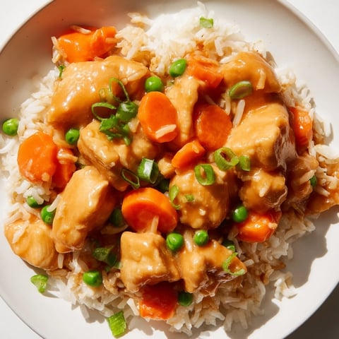 Aromatic Butter Chicken Fried Rice, a vibrant fusion dish served with a sprinkle of green onions.