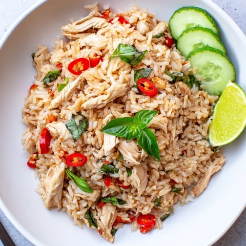 Fragrant Thai basil chicken fried rice, sizzling with chicken, aromatic basil, and colorful peppers.