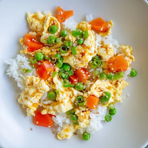 Fluffy egg fried rice classic with vibrant vegetables and a savory soy sauce glaze.