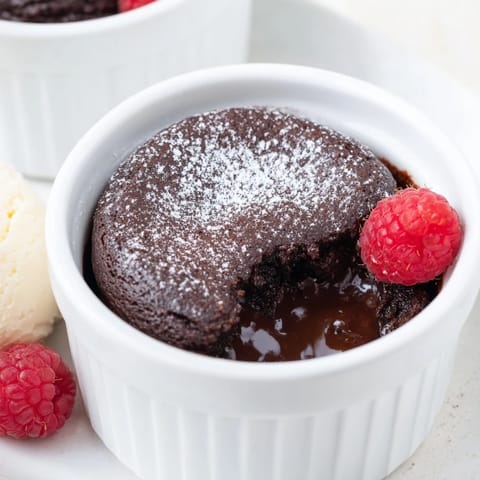 Molten chocolate center spilling from a perfect 5-Minute Quick Chocolate Lava Cake for Two, ideal dessert.
