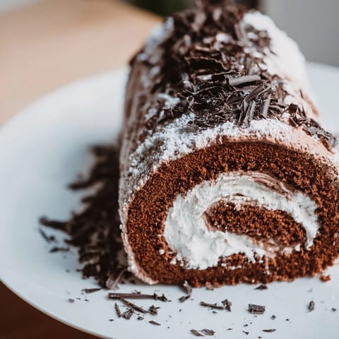This easy Budget Bûche de Noël recipe showcases a chocolate Yule log ready to slice and serve.