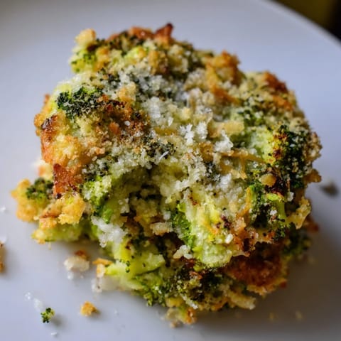 A close-up of delicious Cheesy Broccoli Patties: golden, pan-fried, and ready to enjoy with a meal.