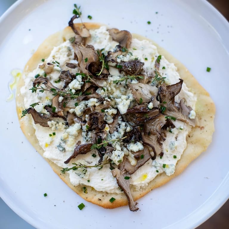 Enjoy a slice of homemade Tarte Flambée, a perfect French flatbread appetizer with savory mushrooms.