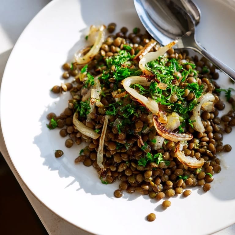 This flavorful warm green lentil salad is ready to serve with a drizzle of vinaigrette.