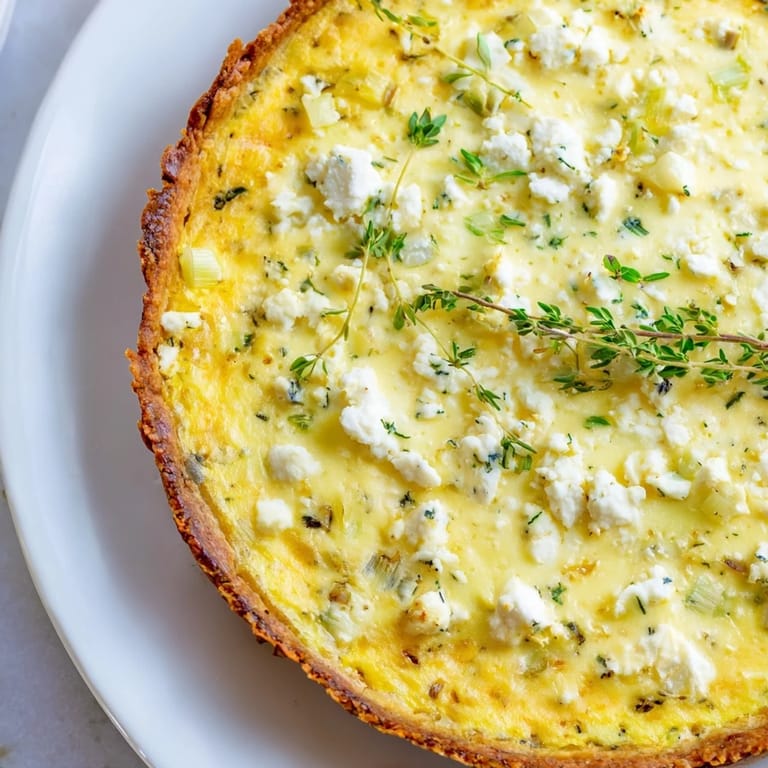 Close-up of the creamy filling in a potato crust leek and goat cheese quiche.