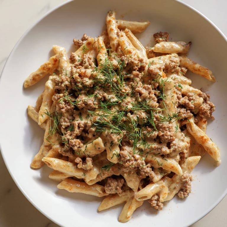 A close-up of flavorful Turkish Pasta with Ground Turkey: the savory dish in a bowl, steam rising.