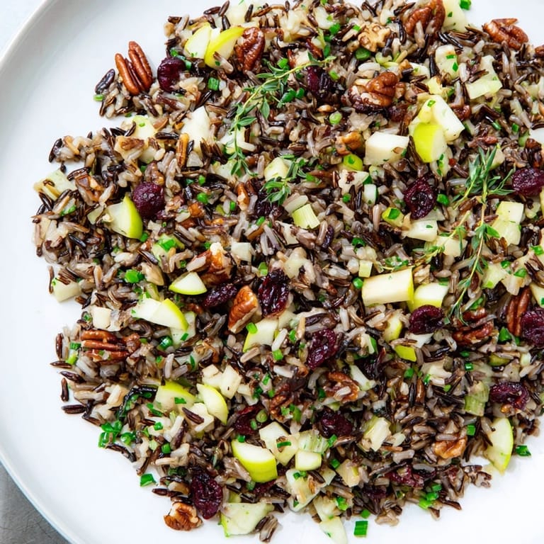 Freshly tossed wild rice harvest salad, a vegetarian delight with bright green herbs and dressing.