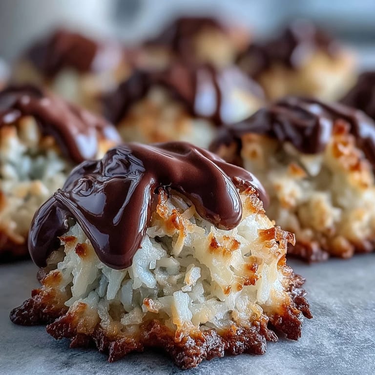 Close-up of Vegan Coconut Macaroons with Dark Chocolate Drizzle showing chewy coconut texture and rich topping.